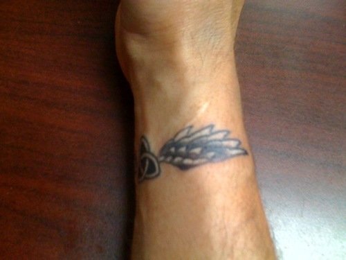 Grey Ink Wings Tattoo On Wrist