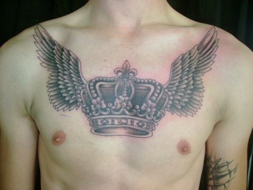 Grey Ink Winged Crown Tattoo On Man Chest