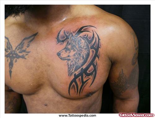 Grey Ink Tribal And Wolf Head Tattoos On Man Chest