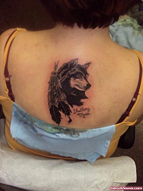 Feathers And Wolf Head Tattoo On Upperback