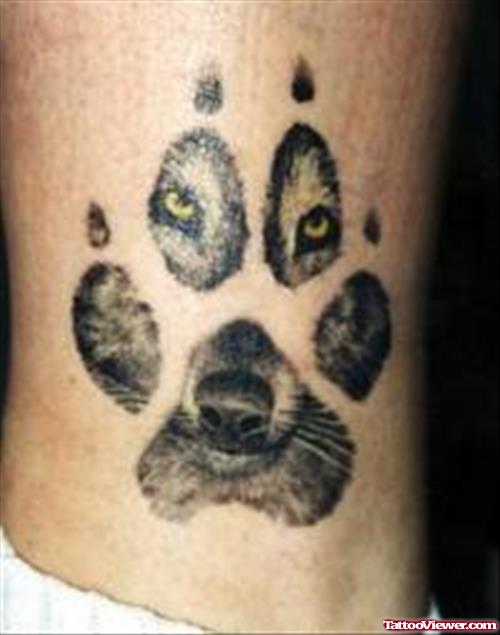 Grey Ink Wolf Face In Paw Print Tattoo