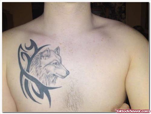 Black Tribal And Wolf Head Tattoo On Man Chest