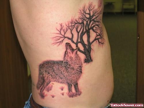 Grey Ink Tree And Wolf Tattoo On Side Rib
