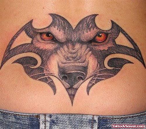 Grey Ink Tribal And Wolf Eyes Tattoo On Lowerback