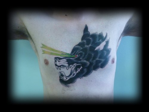 Black Ink Wolf Tattoo On Man Chest