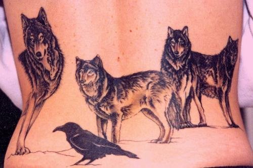 Black Crow And Wolf Tattoos On Lowerback