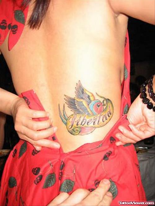Colored Flying Bird And Banner Women Tattoo