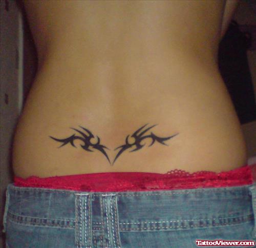 Black Ink Tribal And Tattoo On Lowerback For Women