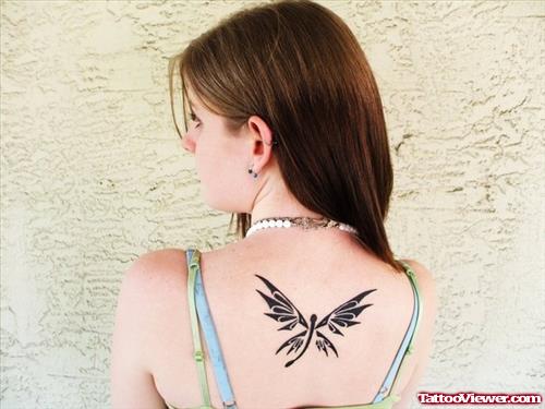 Black Ink Tribal Dragonfly Tattoo On Back For Women