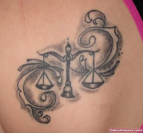 Grey Ink Balance Tattoo On Back For Women