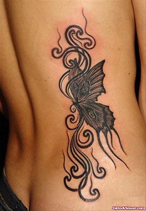 Grey Ink Tribal And Butterfly Tattoo On Back For Women