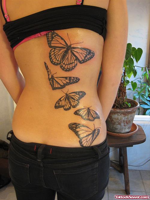 Grey Ink Flying Butterflies Tattoo On Back For Women