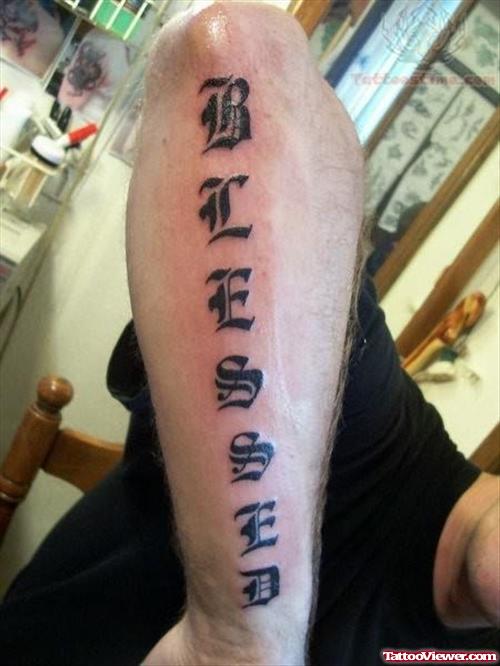 Blessed Written in Old English Font on Arm