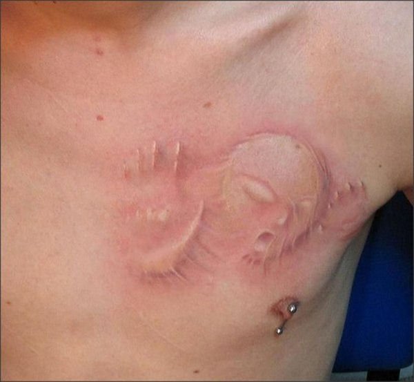 3D Implants Tattoo On Man Chest