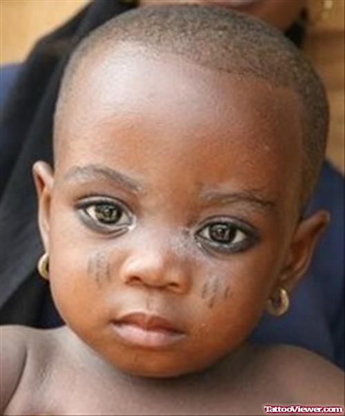 Baby With African Tattoo On Face