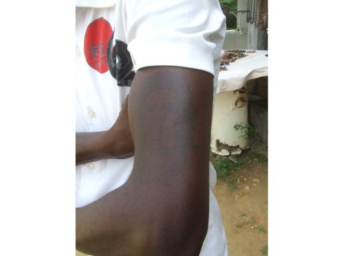 Black African Tattoo On Left Bicep