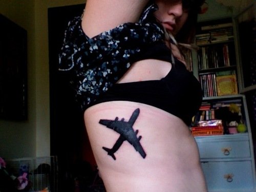 Black Airplane Tattoo On Girl Side Rib