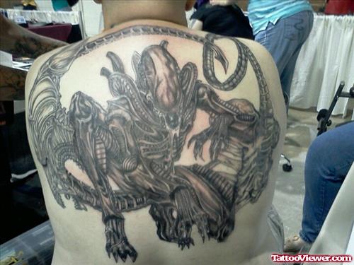 Grey Ink Alien Tattoos On Man Upperback