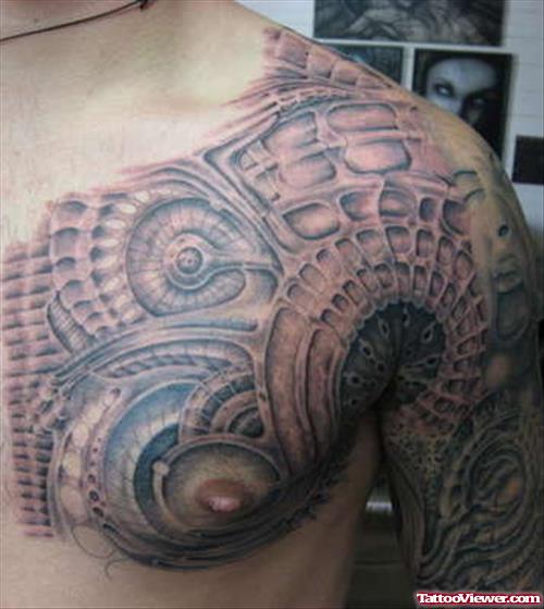 Grey Ink Alien Tattoo On Man Chest And Half Sleeve