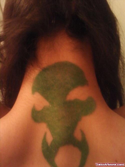Green Ink Alien Tattoo On Girl Back Neck