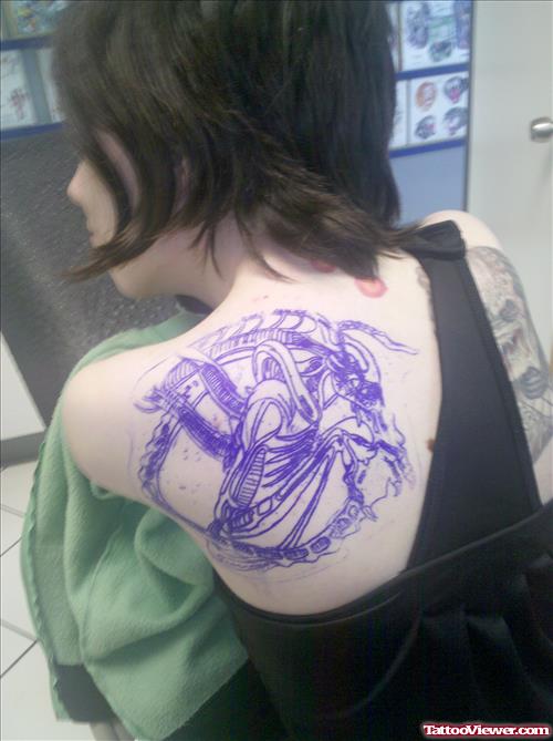 Blue Ink Alien Tattoo On Girl Left Back Shoulder