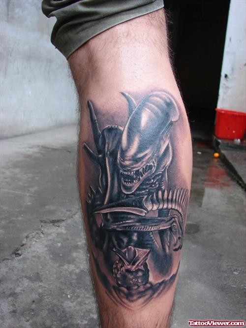 Grey Ink Alien Tattoo On Back Leg