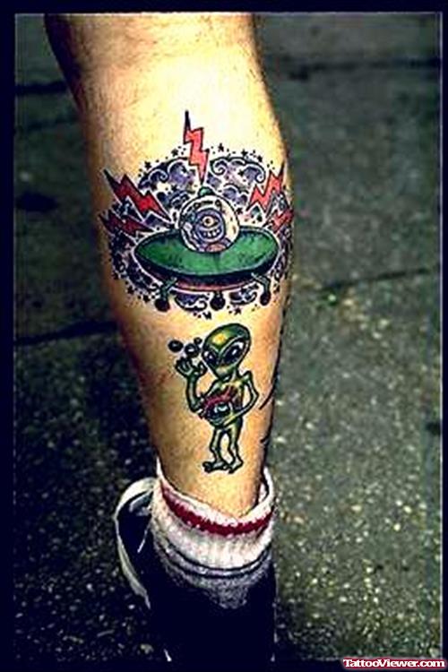 Colored Ink Spaceship And Alien Tattoo On Back Leg