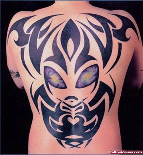 Black Ink Tribal Alien Tattoo On Man Back Body