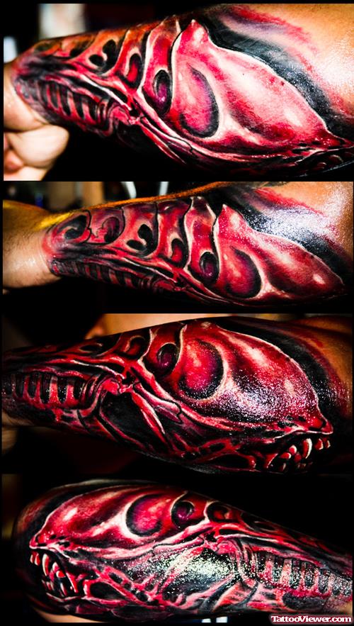 Red Ink Alien Tattoo On Left Arm