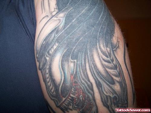 Grey Ink Alien Bicep Tattoo