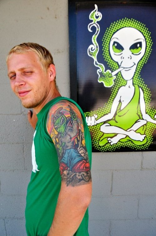 Colored Ink Alien Tattoo On Man Left Half Sleeve