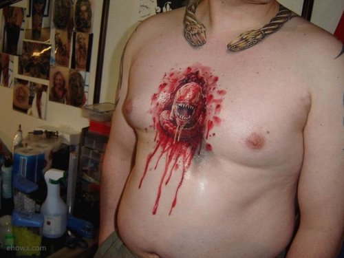 Red Ink Alien Head Tattoo On Man Chest