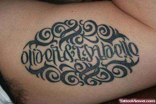 Black Ink Tribal And Ambigram Tattoo On Muscles