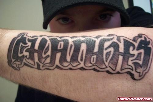 Ambigram Grey Ink Tattoo On Left Arm