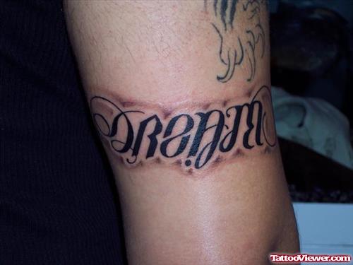Believe Dream Ambigram Tattoo On Bicep