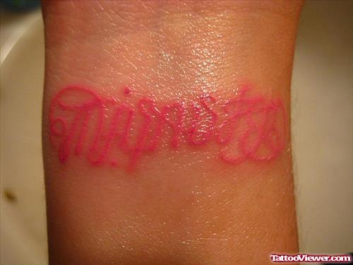 Red Ink Ambigram Tattoo On Wrist