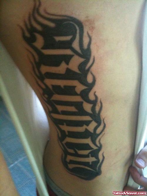 Regret Ambigram Tattoo On Side Rib