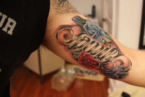 Colore Flowers And Ambigram Family Tattoo On Left Bicep