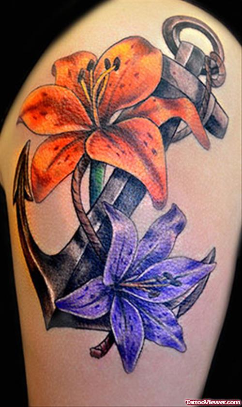 Purple And Orange Flowers Anchor Tattoo On Shoulder