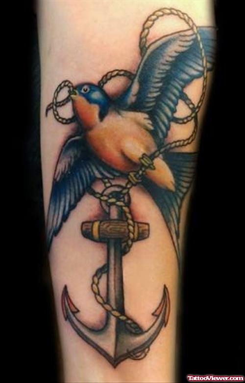 Awesome Colored Flying Bird And Anchor Tattoo
