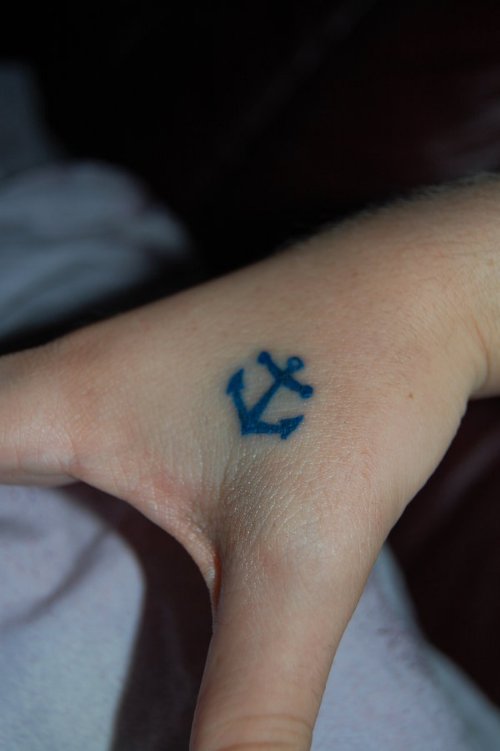 Tiny Blue Anchor Tattoo On Hand