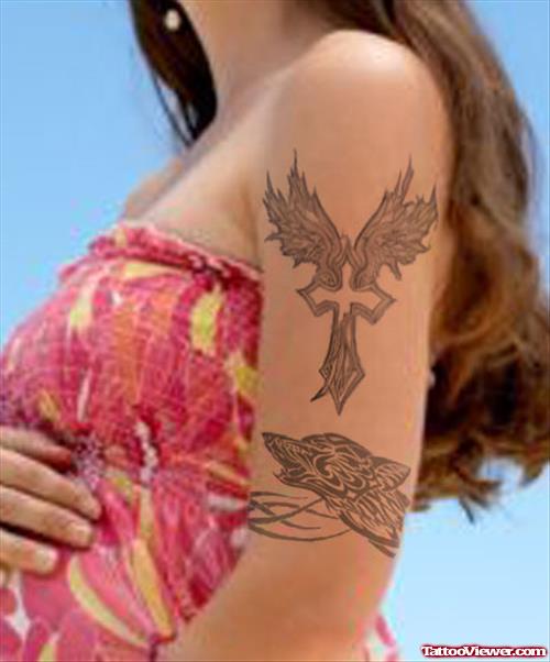 Grey Ink Angel Winged Cross Tattoo On Left Bicep For Girls