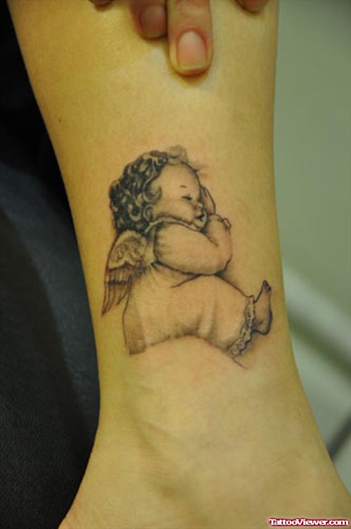 Cute Baby Angel Tattoo On Leg
