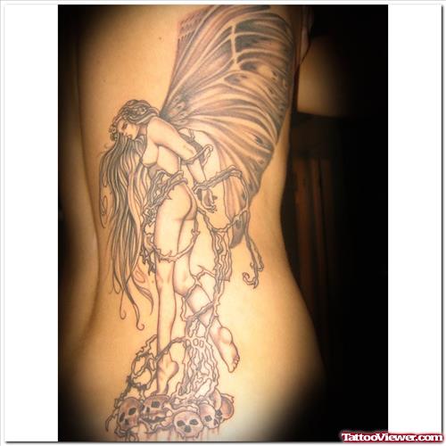 Grey Ink Angel On Skulls Tattoo On Side Rib