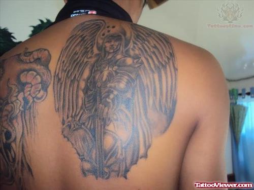 Grey Ink Angel With Sword Tattoo On Back Shoulder