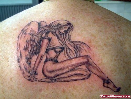 Grey Ink Animated Angel Girl Sitting Tattoo On Upperback