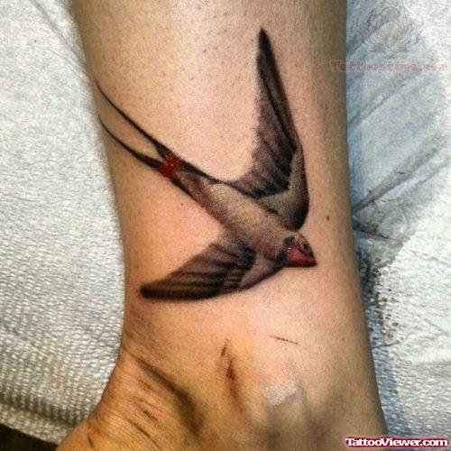 Grey Ink Flying Ankle Tattoo On Ankle