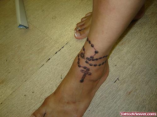 Grey Ink Rosary Cross Ankle Tattoo For Girls