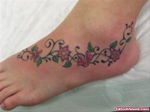 Red Flowers Tattoo On Left Ankle