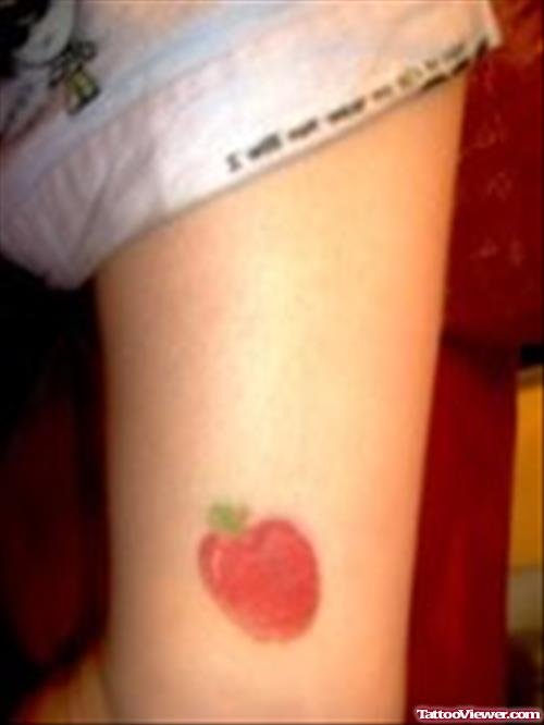 Small Red Apple Tattoo On Bicep